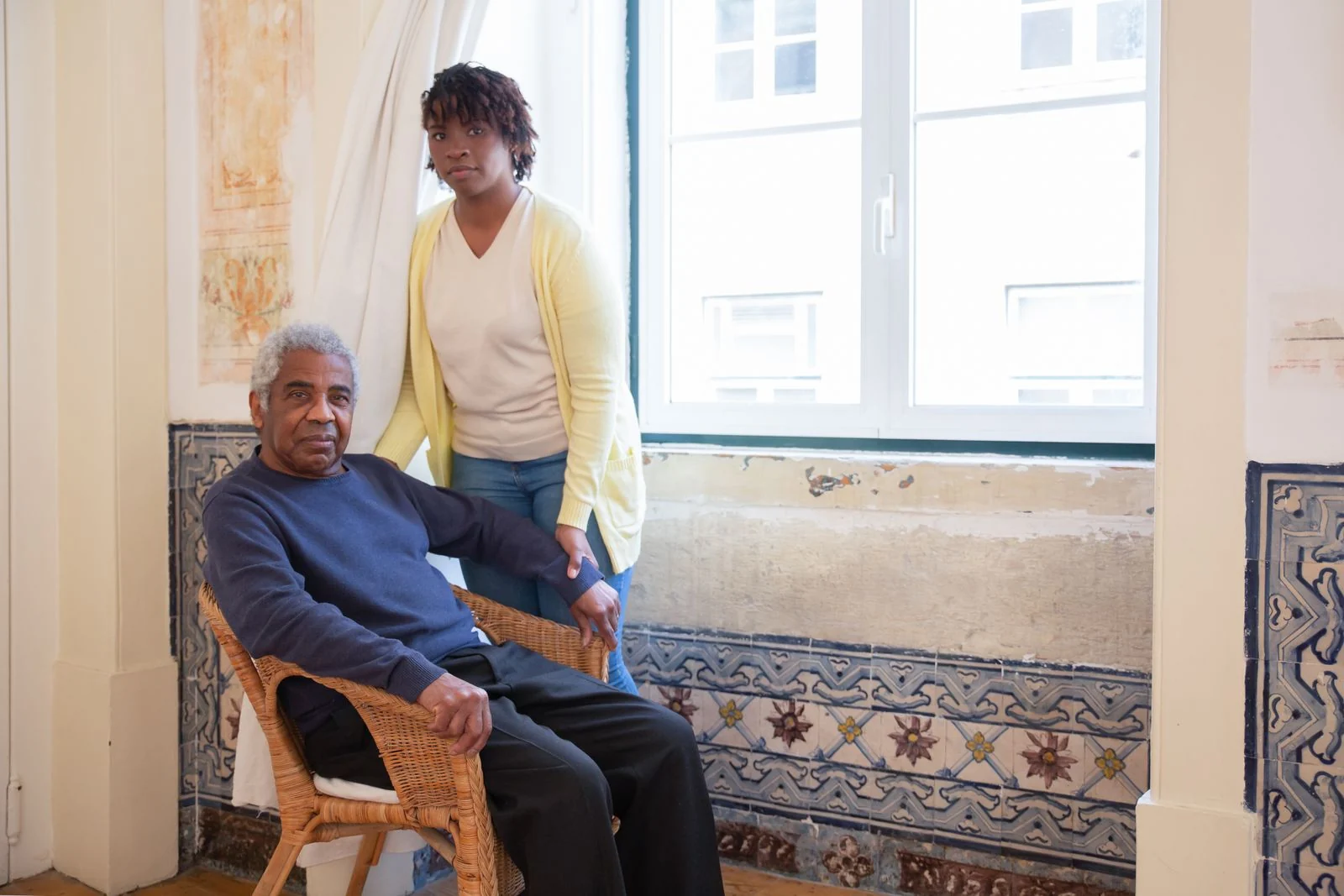 A caregiver visiting and supporting a senior in his home