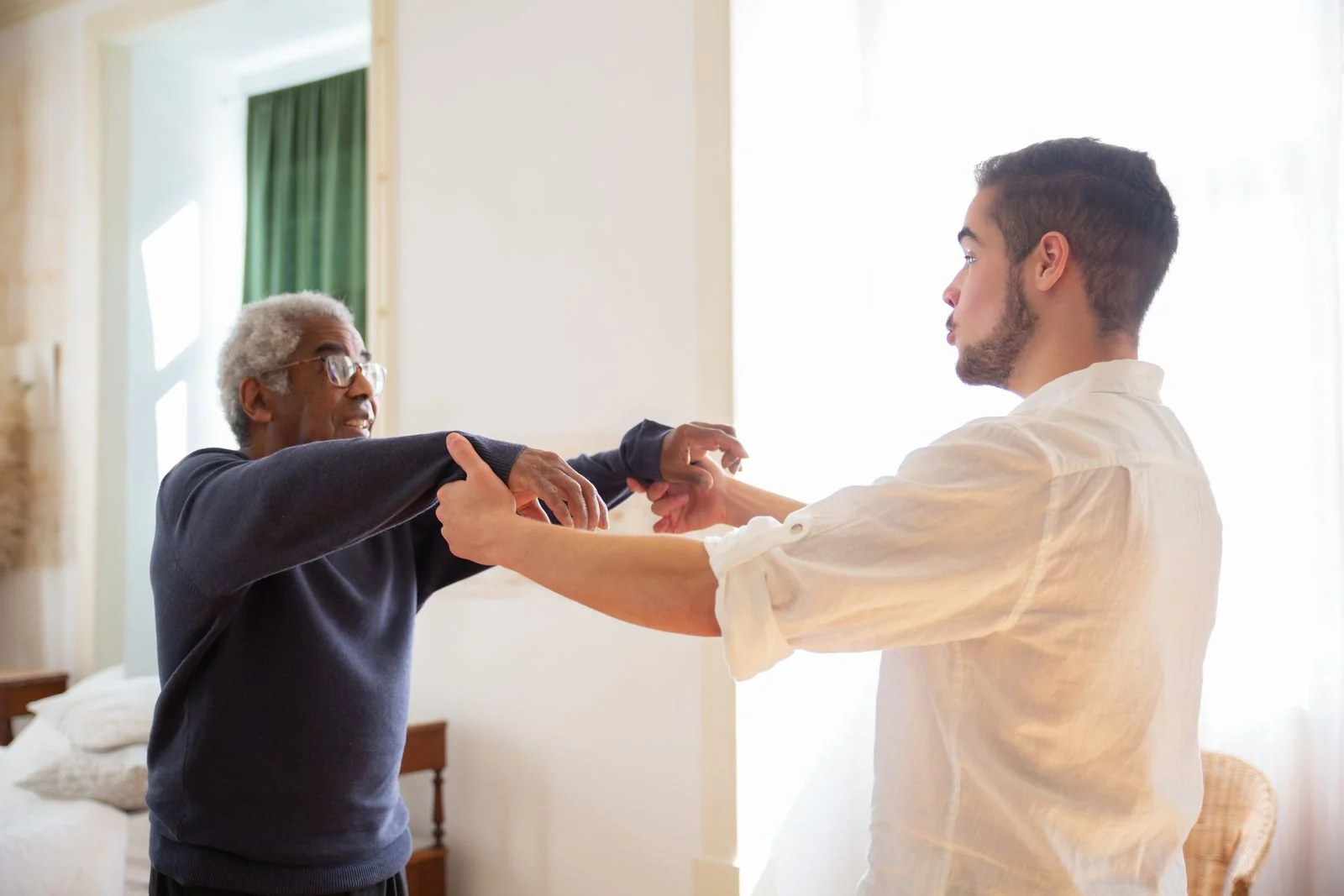 A caregiver helping a senior maintain movement and confidence at home