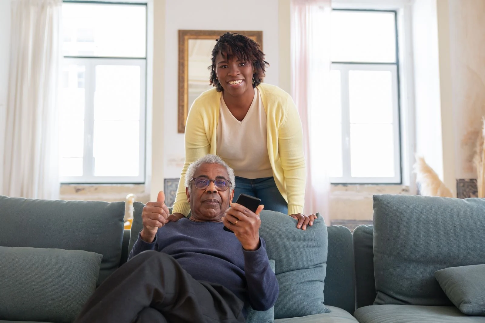 A caregiver sharing relaxed companionship with a senior at home