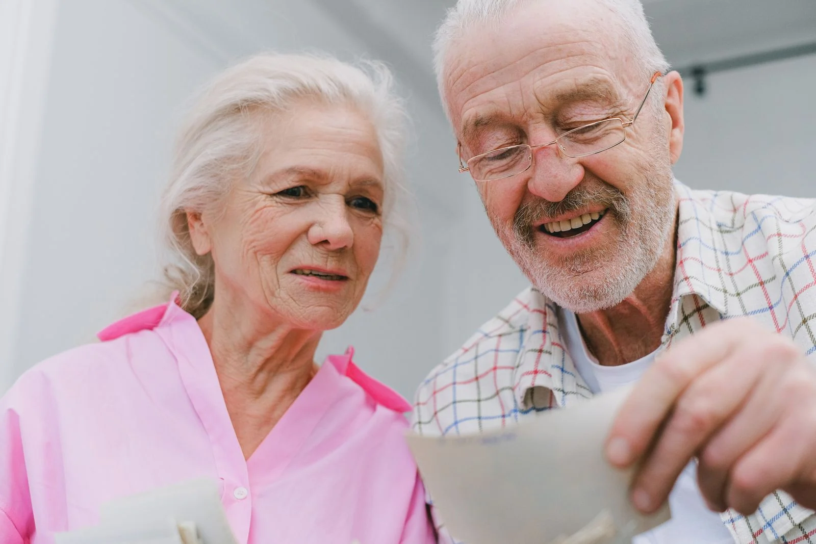A senior couple sharing familiar photographs and memories together